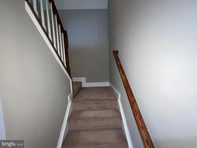 a view of staircase with wooden floor and stairs