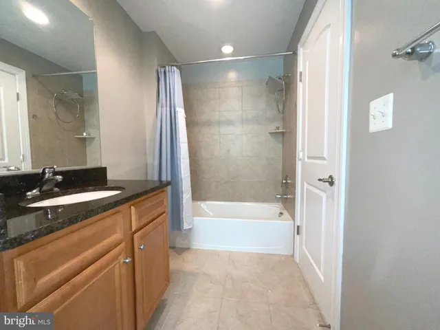 a spacious bathroom with a toilet sink and mirror
