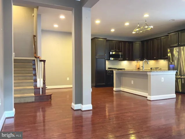 a view of kitchen with cabinets and wooden floor