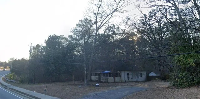 a view of a room with a bench and trees
