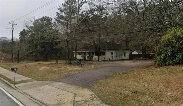 a view of a street with a car parked on the road