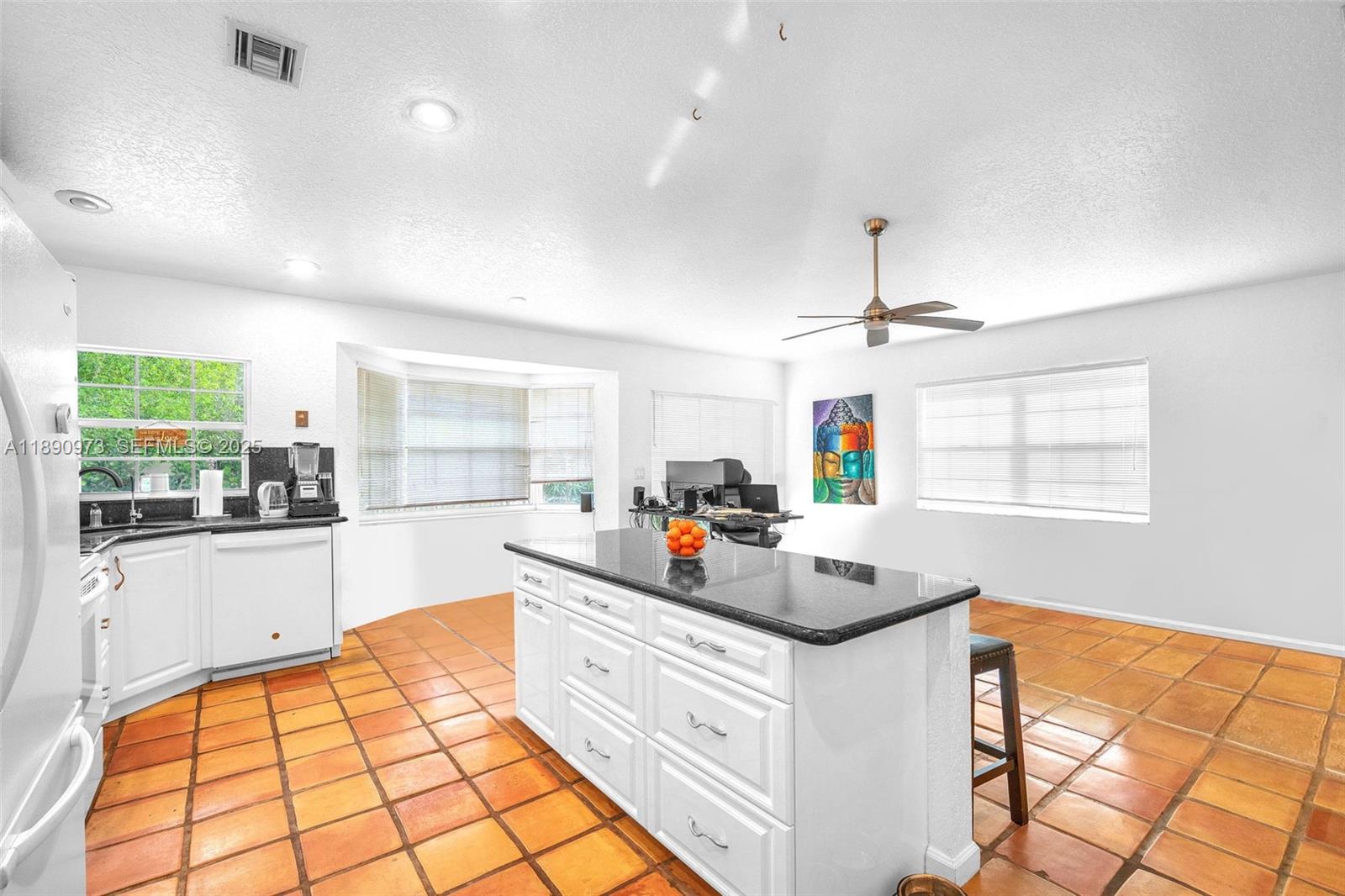 9690 Northwest 39th Street Cooper City, FL 33024 - Photo 12 of 30 a kitchen that has a lot of cabinets a sink and a wooden floor in it