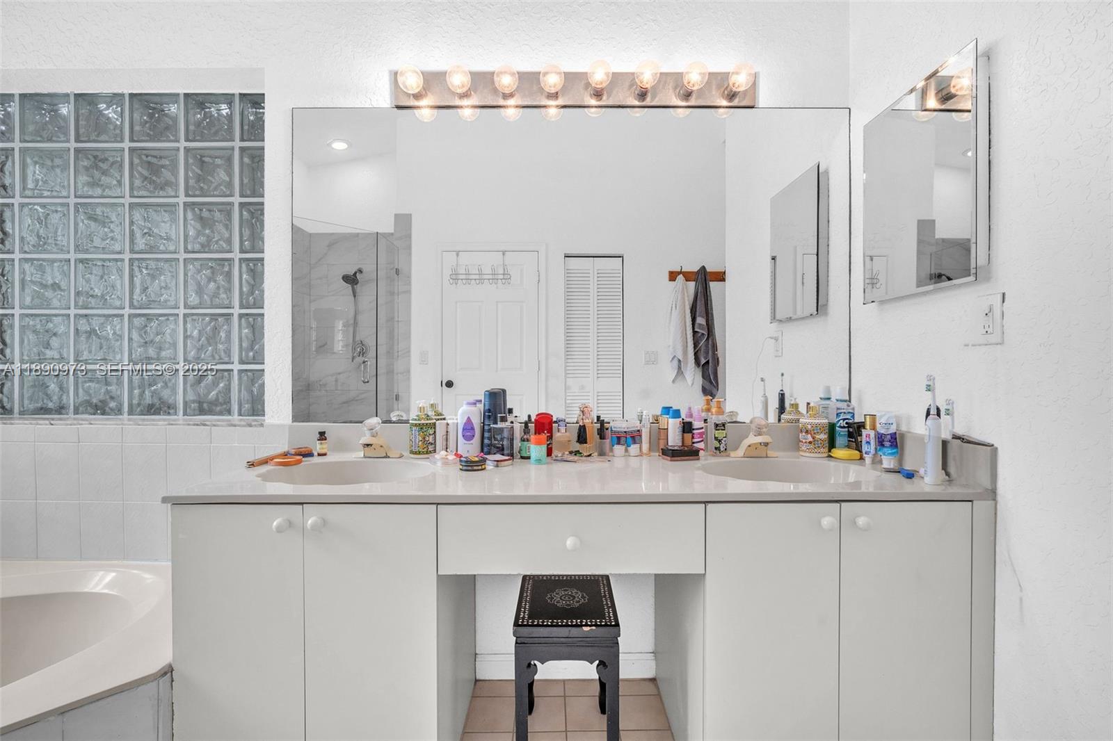 9690 Northwest 39th Street Cooper City, FL 33024 - Photo 16 of 30 a bathroom with a sink and a mirror