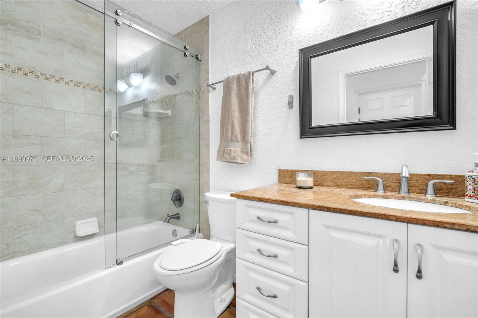 9690 Northwest 39th Street Cooper City, FL 33024 - Photo 23 of 30 a bathroom with a toilet a sink and bathtub