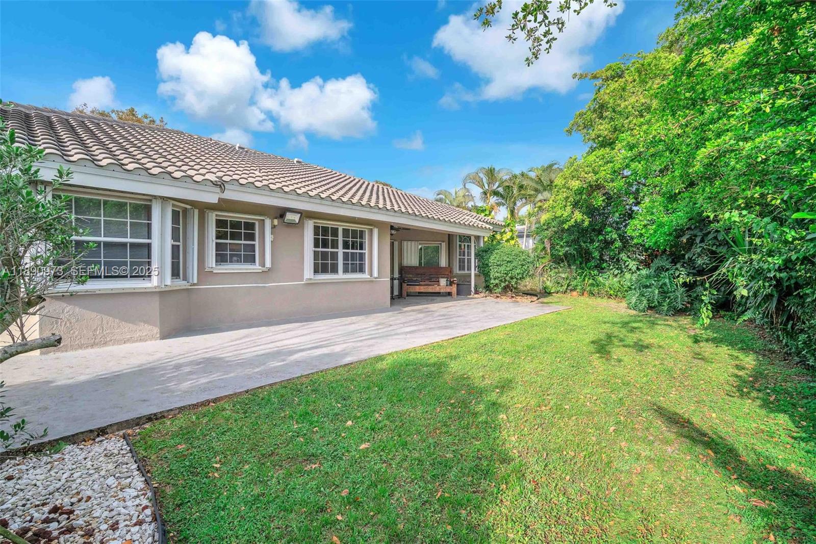 9690 Northwest 39th Street Cooper City, FL 33024 - Photo 27 of 30 a view of house with backyard and a garden