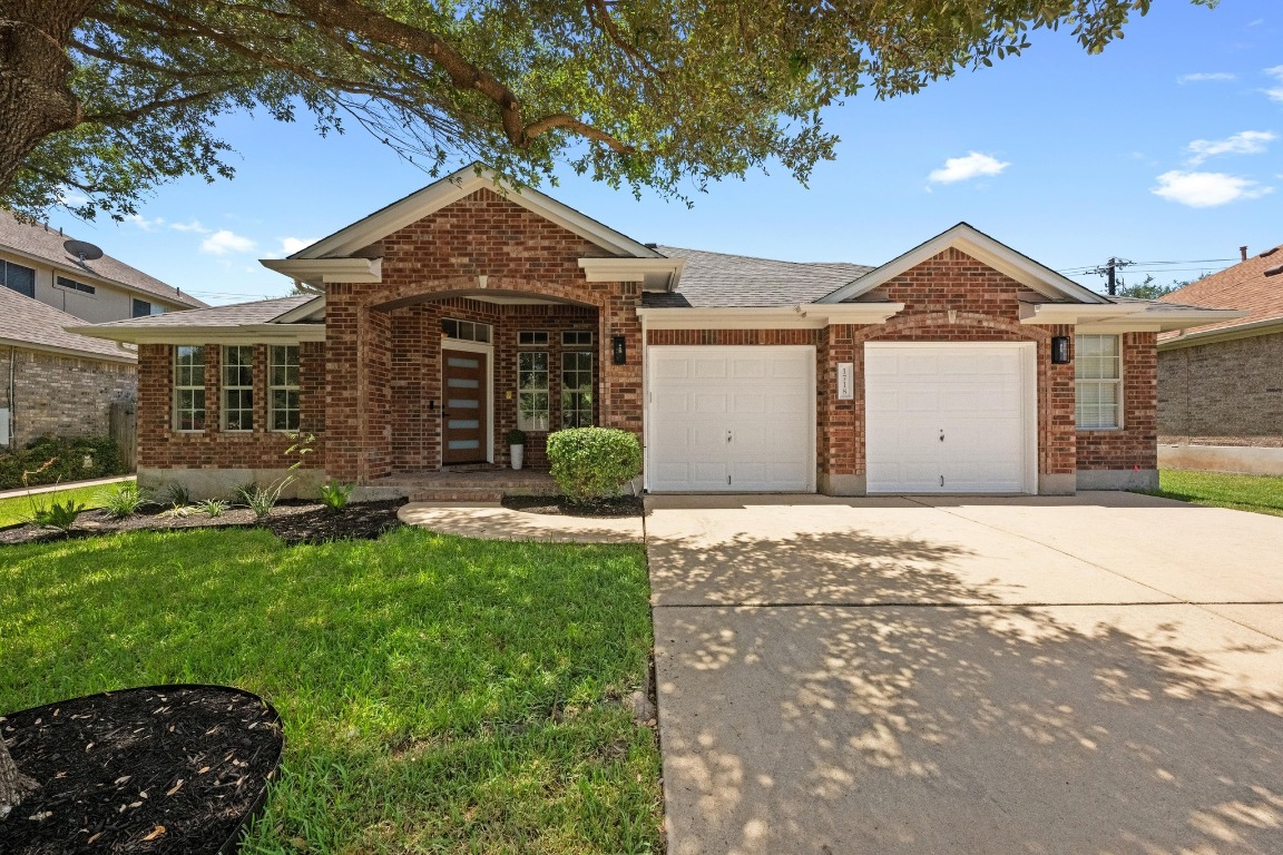 1718 Cattle Drive Cedar Park, TX 78613 - Photo 1 of 1 a front view of a house with a yard and garage