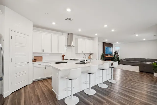a kitchen with stainless steel appliances a sink stove and cabinets