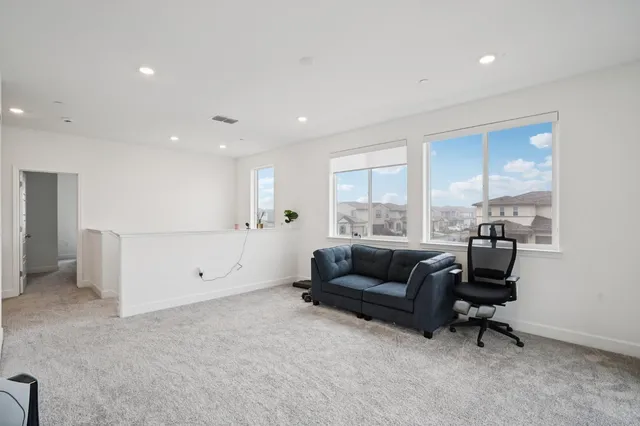 a living room with furniture and a floor to ceiling window