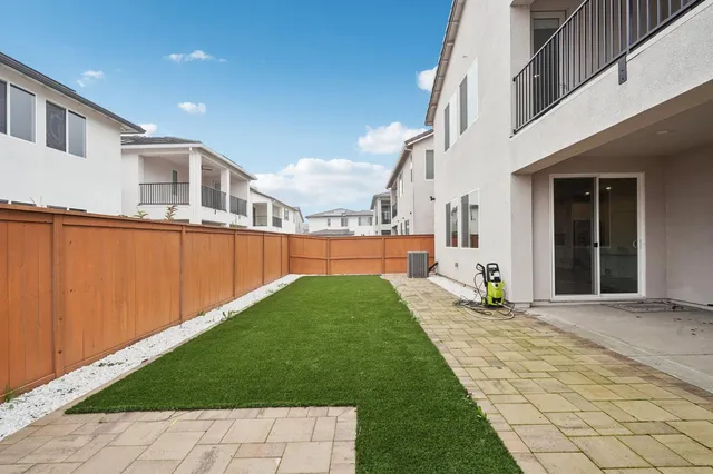 a living room with furniture and floor to ceiling windows