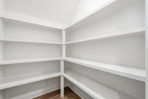 a kitchen with a sink a stove a dining table and chairs