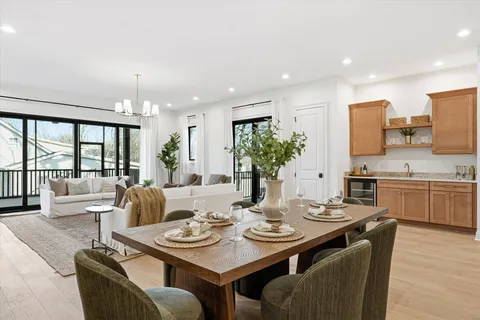 a living room with furniture a fireplace and a large window