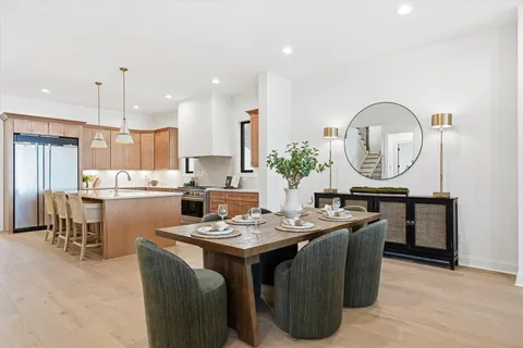 a living room with furniture kitchen and a chandelier