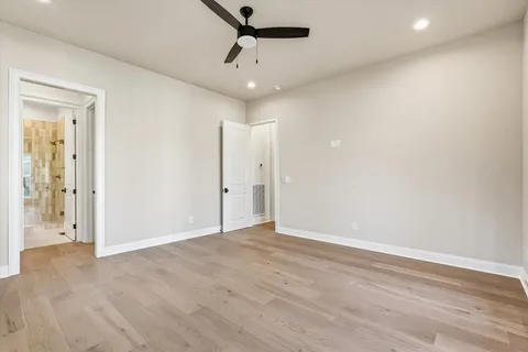 a spacious bedroom with a bed and window