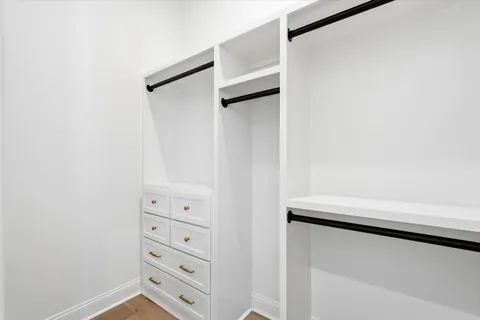 a bed room with a bed and a potted plant