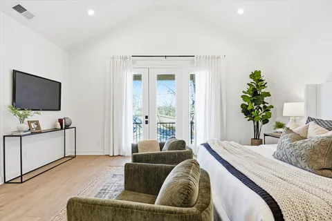 a view of a room with wooden floor and a ceiling fan