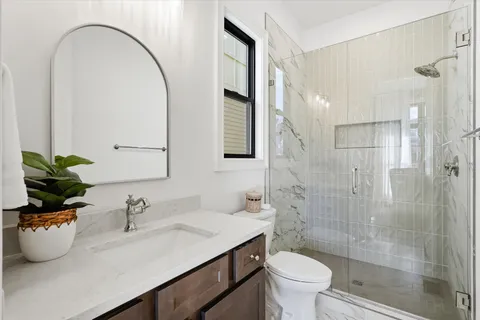 a kitchen with stainless steel appliances granite countertop a table chairs sink and stove top oven