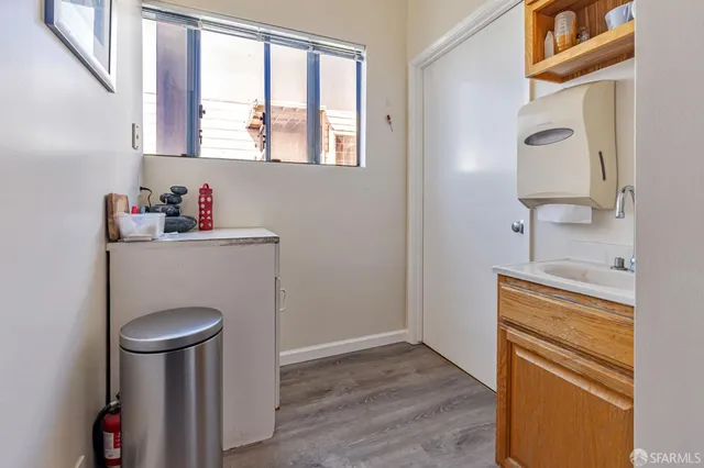 a spacious bathroom with a granite countertop sink a toilet and a mirror