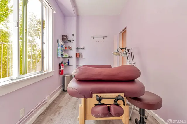 a bedroom with a bed and a wooden floor
