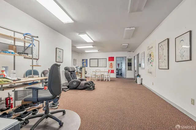 a dining room with furniture and wooden floor