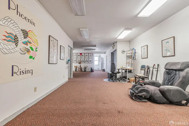 a living room with furniture a piano and a desk
