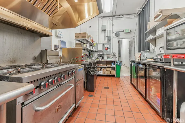 a view of a kitchen with stainless steel appliances granite countertop a stove and a sink