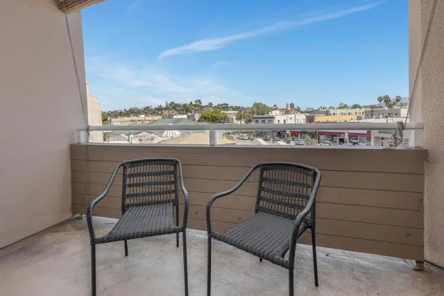 a view of a chairs and table in a balcony
