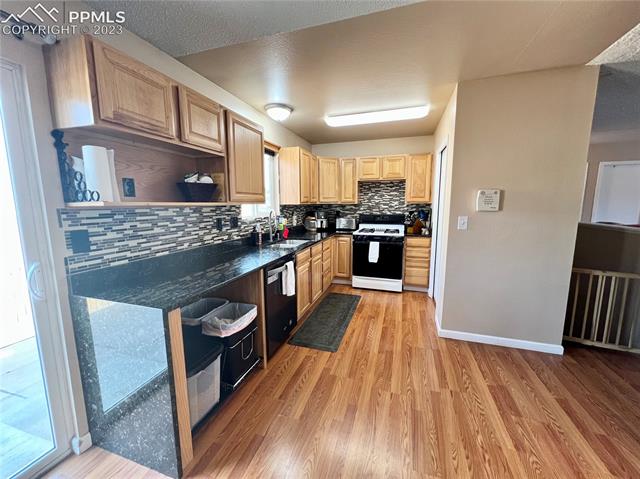 700 Rye Ridge Road Fountain, CO 80817 - Photo 7 of 27 Granite counters complete with waterfall style overhang.