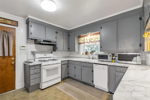 a kitchen with a sink a stove a refrigerator and cabinets