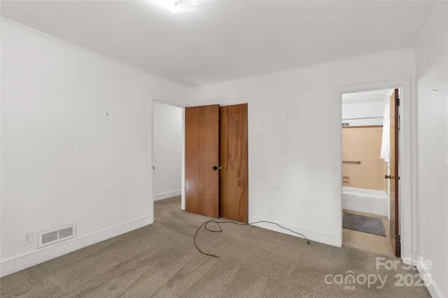 an empty room with closet area