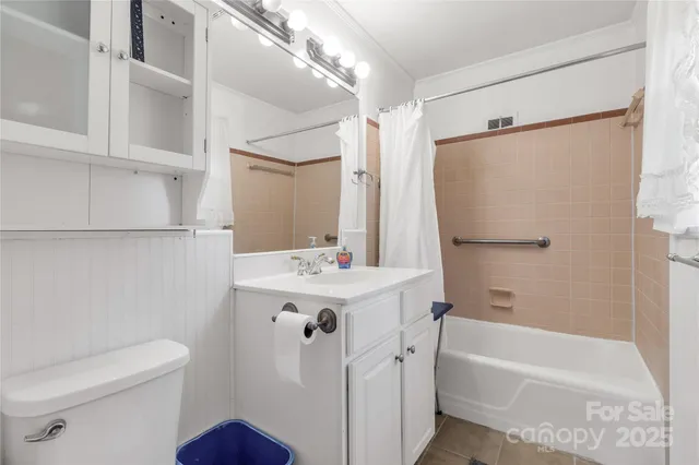 a bathroom with a sink mirror toilet and bathtub