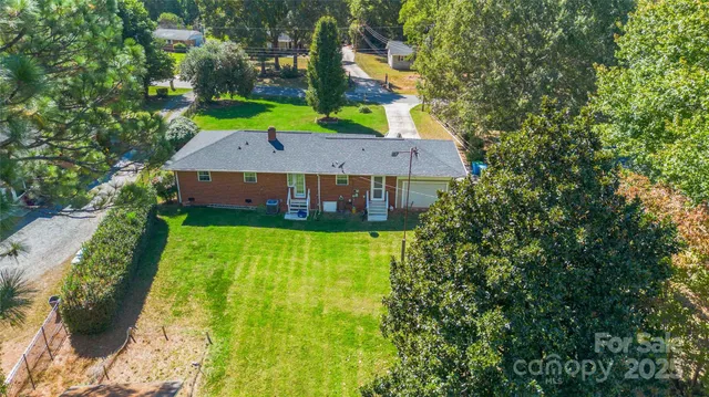 a view of yard with swimming pool and green space