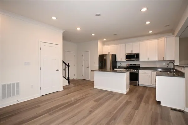 a kitchen with stainless steel appliances a refrigerator and a stove top oven