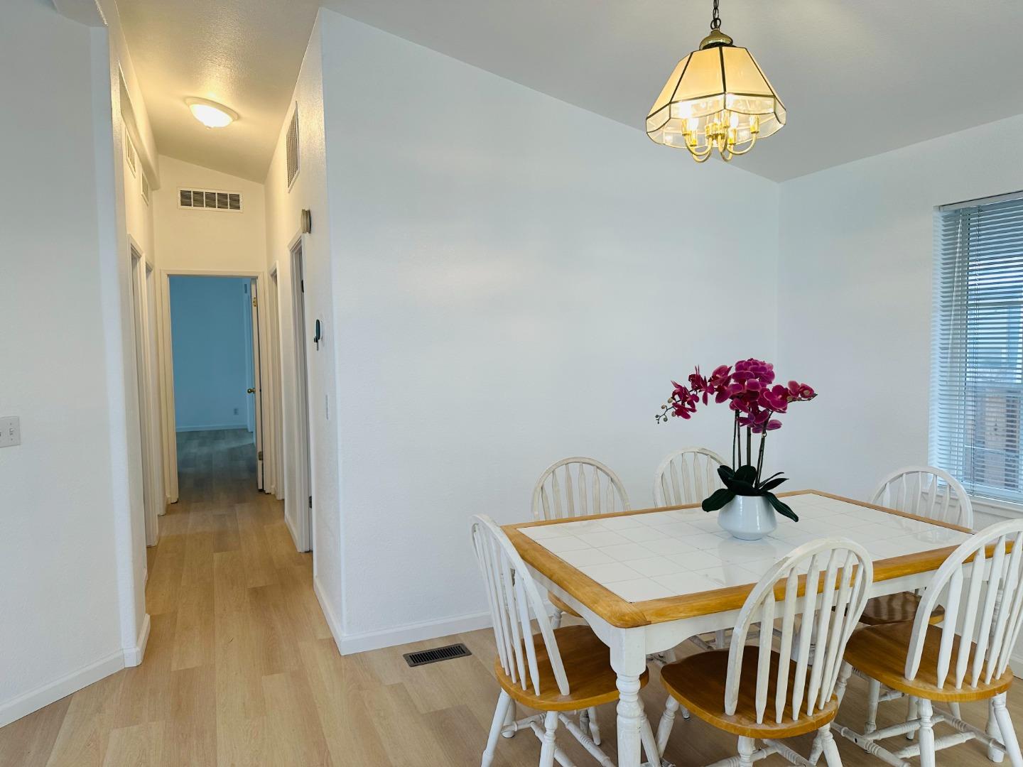 200 Ford Road, Unit 227 San Jose, CA 95138 - Photo 11 of 27 a dining room with furniture and chandelier