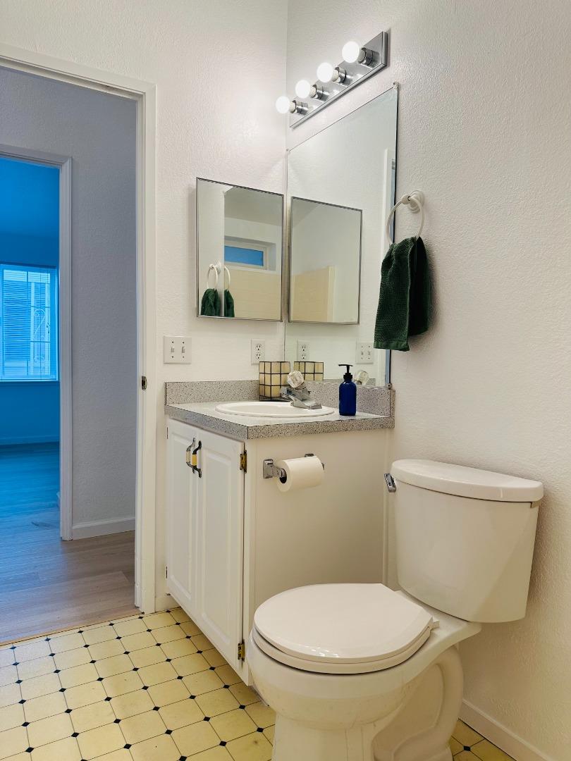 200 Ford Road, Unit 227 San Jose, CA 95138 - Photo 15 of 27 a bathroom with a toilet a sink and a mirror