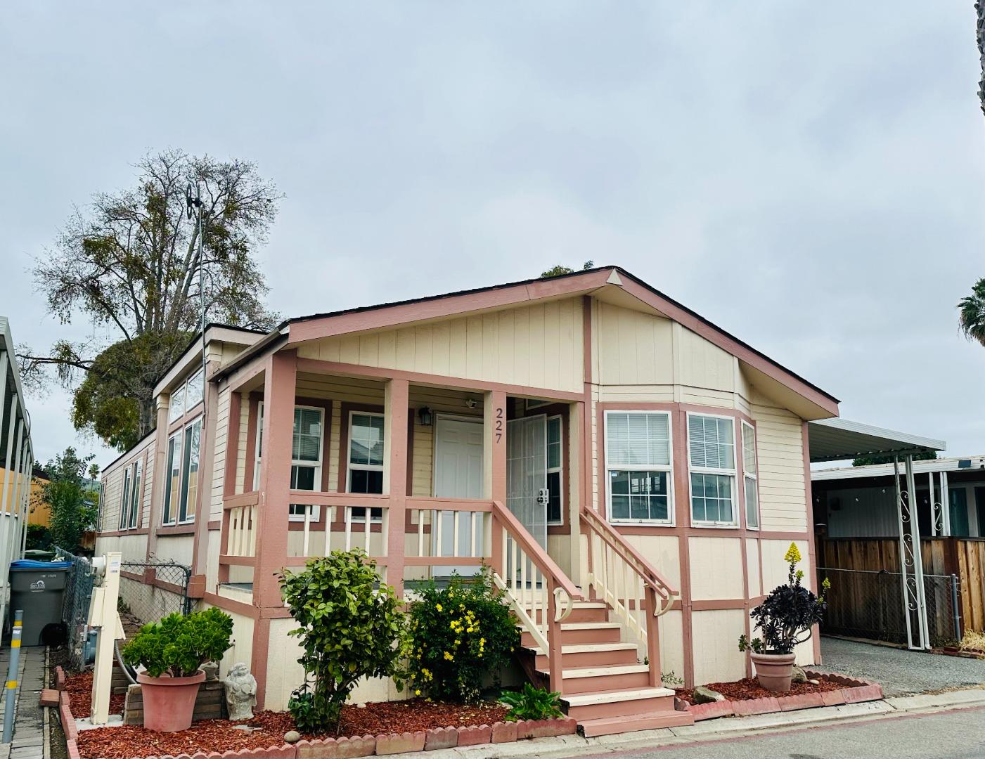 200 Ford Road, Unit 227 San Jose, CA 95138 - Photo 2 of 27 a view of a white house with large windows and a small yard