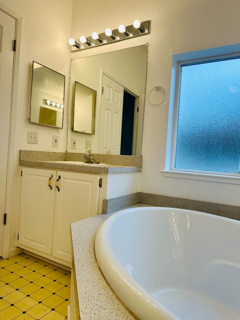 200 Ford Road, Unit 227 San Jose, CA 95138 - Photo 24 of 27 a bathroom with a sink a mirror and a bathtub