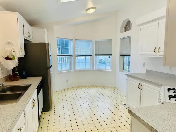 a kitchen with a sink a refrigerator and a stove