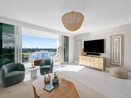 a living room with furniture a flat screen tv and a large window
