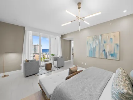 a bedroom with furniture and a large window