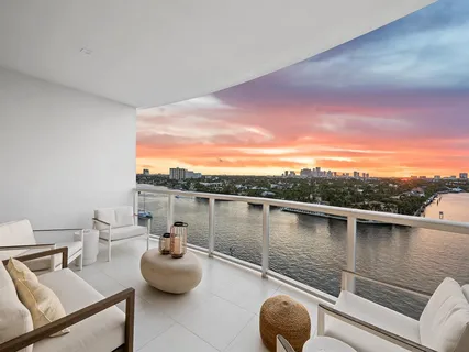 a view of a balcony with chair and potted plants