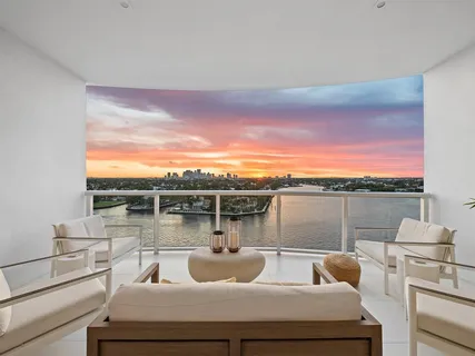 a view of a roof deck with couches and sky view