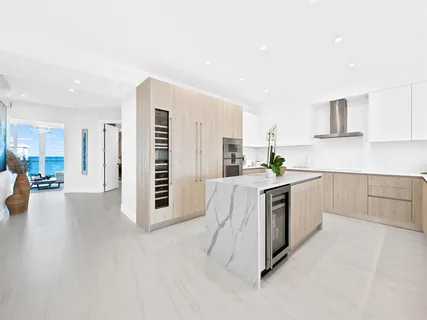 a kitchen with granite countertop a stove a sink and a refrigerator