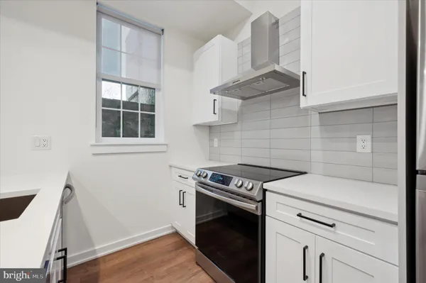 a kitchen with a stove and a microwave