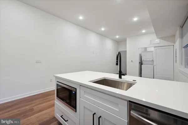 a kitchen with a sink and refrigerator
