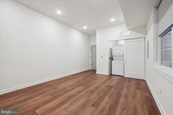 a view of an empty room with wooden floor