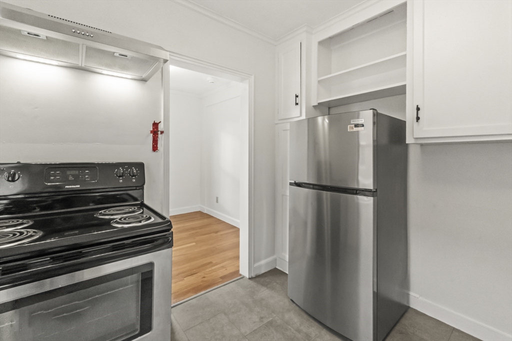 38-40 Cedar Street, Unit 141 Worcester, MA 01609 - Photo 13 of 26 a kitchen with a refrigerator and a stove