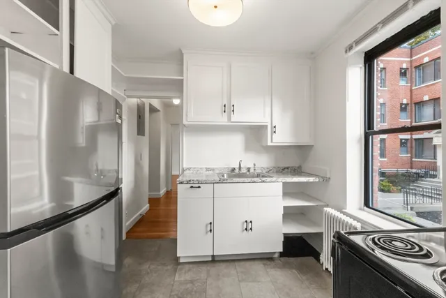 a kitchen with stainless steel appliances granite countertop a stove and a refrigerator