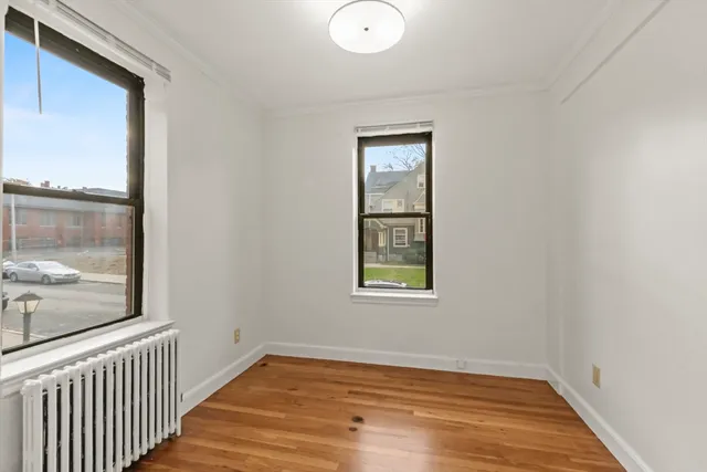 a view of a room with wooden floor and windows