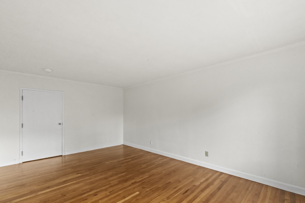 38-40 Cedar Street, Unit 141 Worcester, MA 01609 - Photo 23 of 26 a view of an empty room with wooden floor