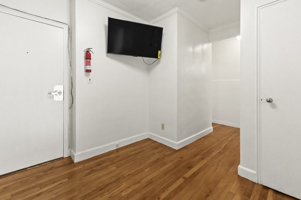 38-40 Cedar Street, Unit 141 Worcester, MA 01609 - Photo 24 of 26 a view of an empty room with wooden floor and a window